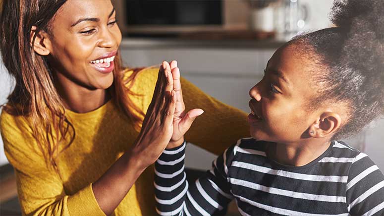 African American mother and daughter high five